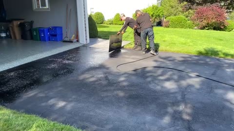 Professional Asphalt Spray Sealing: “The Friendly Lady One” Top Coats Pavement Maintenance