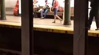 Guy upside down handstand subway bench black shirt khaki pants