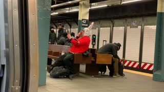 New york subway rabbit man in red shirt records himself singing loudly in subway station