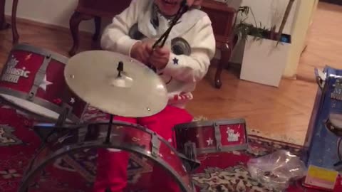 the baby plays drums