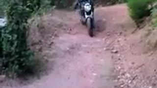 Guy trying to do flip while riding motorcycle falls