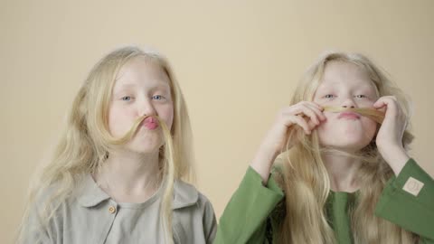 Two blond twin sisters, very beautiful