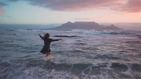 A woman running towards the sea