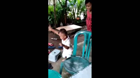A 3 year old child dances when he hears his favorite music.