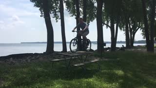 Kid rides bike off park bench and immediately falls face first, bike lands on him