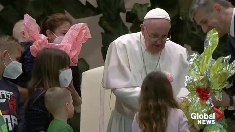 Pope Francis holds up Ukrainian flag from Bucha, condemns "new atrocities"