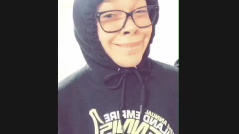 College student girl in hoodie and glasses, makes weird faces to "let's get it on" song