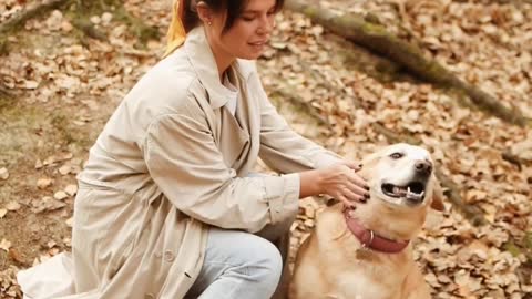 Young woman petting her dog outdoors