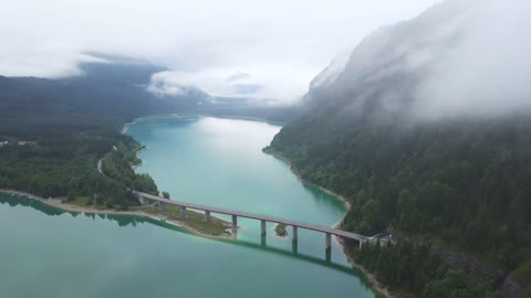 Drone Footage of Mountain Forest and a Bridge Above the Lake