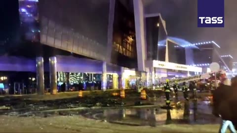 Firefighters try to put out the fire at the Crocus City Hall in Moscow