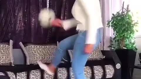 A lady performs soccer freestyle