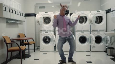 Joyful Man in mask horse Dancing Cheerful In Laundry Room