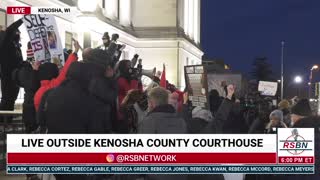 A man calls for unity and prayer outside the courthouse in Kenosha