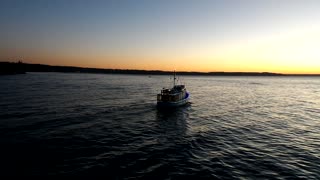 Boat sailing into the sunset on Christmas