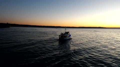 Boat sailing into the sunset on Christmas