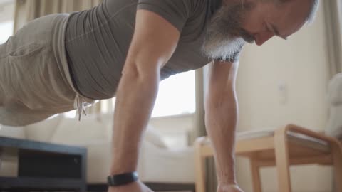 Watch a man play push-ups