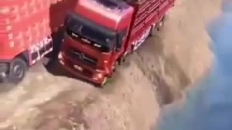 Truck driver risking his life at road edge