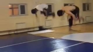 Two guys flip onto blue foam floor fail