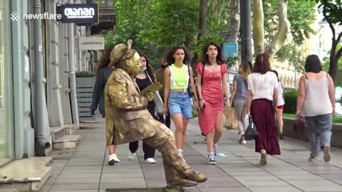 Practical joker dressed as statue scares public with funny prank