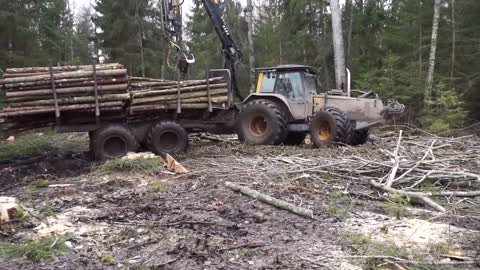 Valtra forestry tractor logging in wet conditions