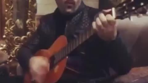 Guy playing guitar and singing Ebi's song