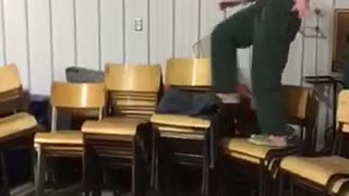 Girl in santa costumer walks across chairs falls on ribs