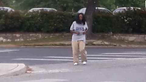 Crazy lady dances in the middle of the street