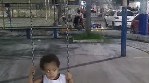 kid on the swings