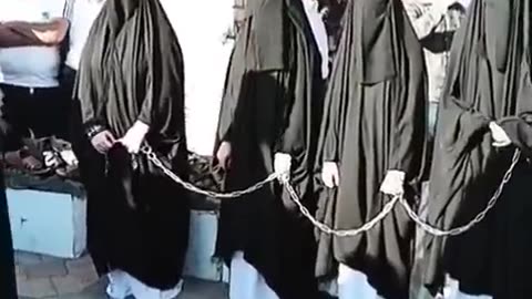 This is an Islamic Sex Sclave market in Iraq women with Burka are sold and they are in chains.