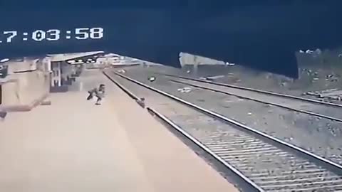 Man runs onto train tracks to save a child