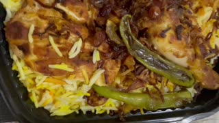 Kabsa rice with vegetables and chicken on plate