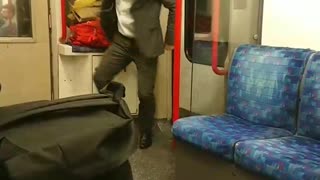 Suit man dances with white headphones in subway