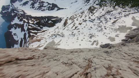 Drone footage of a mountain landscape with snow