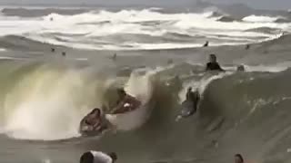 Bunch of surfers run into each other in barrel of wave