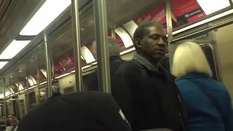 Man holding a cane gets in an argument with man wearing adidas jacket on subway train