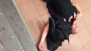 Man passed out on the floor and the end of subway stairs