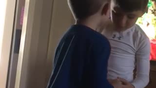 Kid in blue shirt slaps kid in white shirt