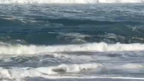 Old shirtless man hit by waves tumbles