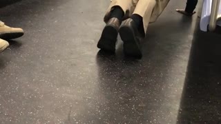 Man does push ups on the floor of subway train