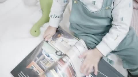 A Little Girl Looking At A Book