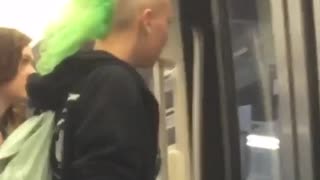 Guy with big green mohawk getting off subway train