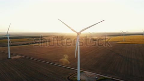 stock-footage-large-wind-turbines-with-blades-in-field-aerial-view-bright-orang.mp4