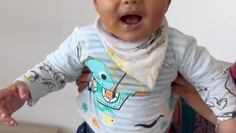 Baby eating mango