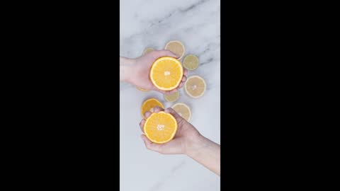 Squeezing By Hand The Slices Of Orange Fruits