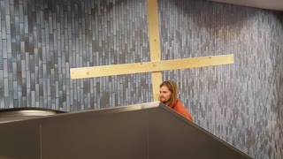 Jesus Carries His Cross in an Escalator