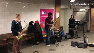 Man sleeps directly behind band on subway