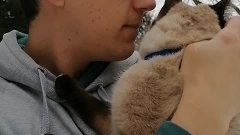 cuddling a cat who is afraid of the snow