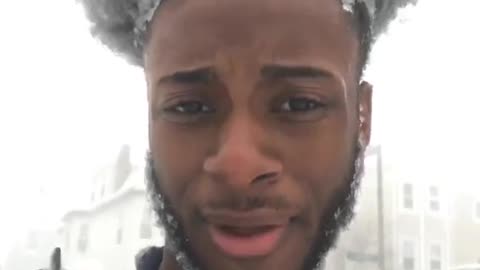 Guy blue sweater hair covered in snow