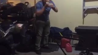 Music country music guy in blue sweater throws dark and hits beer can on wall