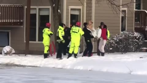 The dog fell into the frozen pool. The firemen started to rescue